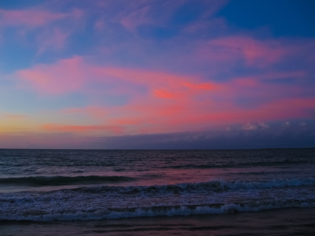 image of the sun setting over the ocean
